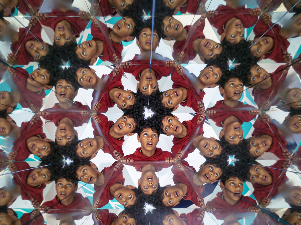 A young man's face is multiplied through the Kaleidoscope at Museum of Illusions Manchester.