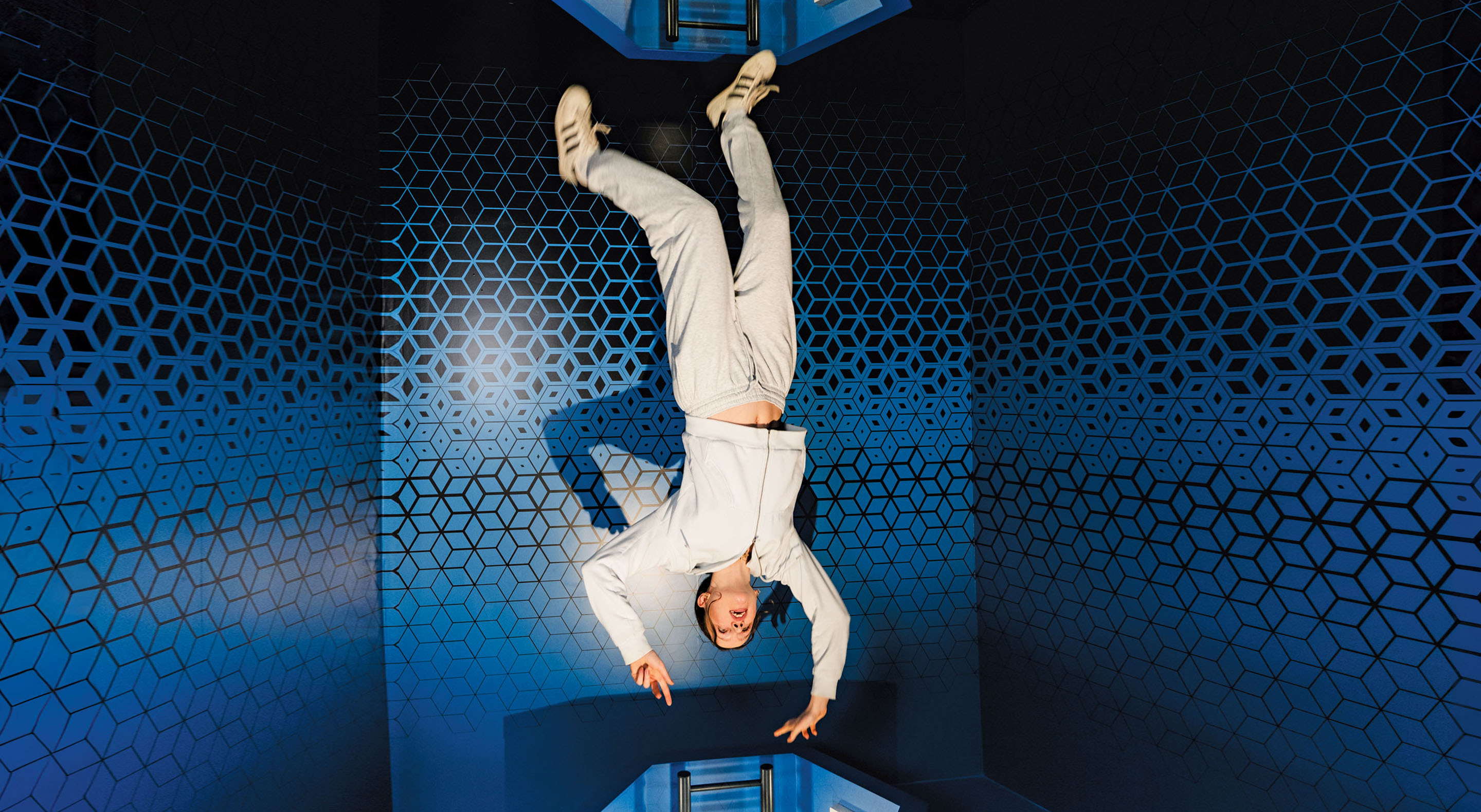 A visitor appears to fly upside-down into an Infinity Portal at Museum of Illusions.
