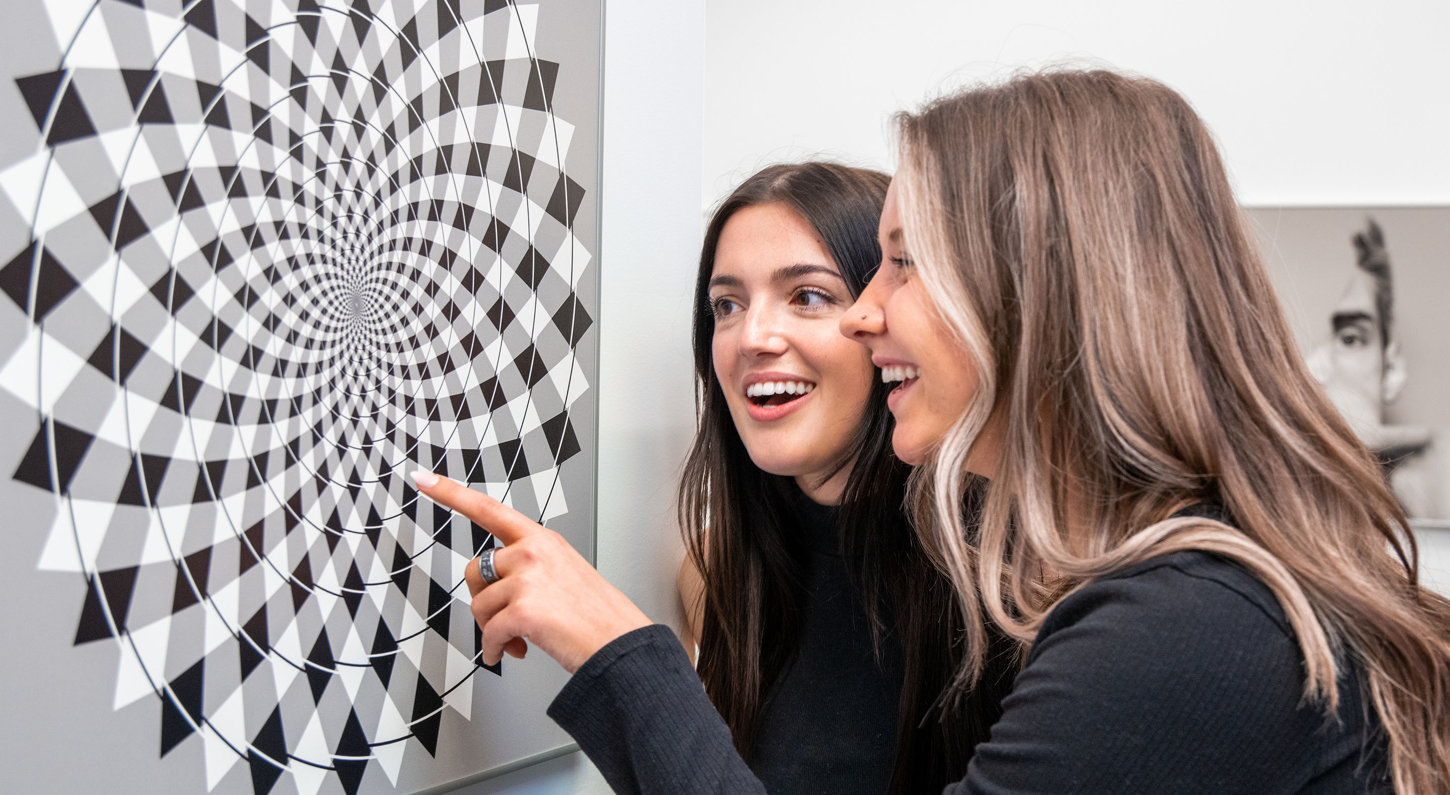 Visitors are interacting with the Fraser Spiral illusion.